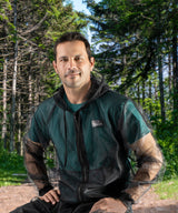 Black ShrugBug jacket with the woods behind
