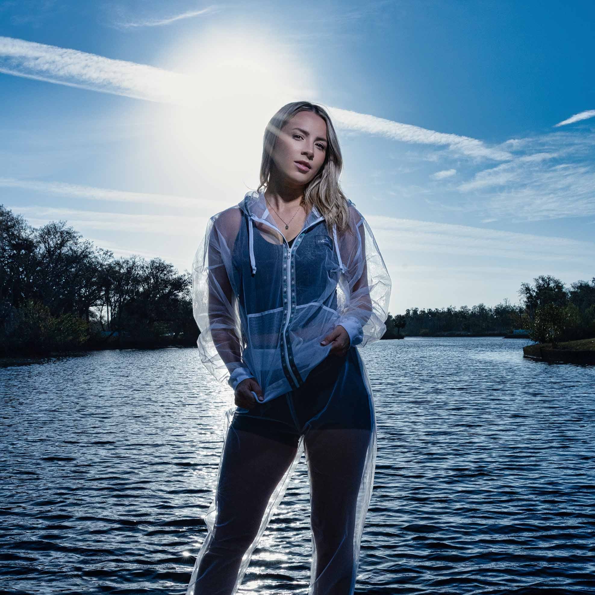 Sheer mosquito net jacket in front of the lake with the sun behind. 