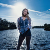 Sheer mosquito net jacket in front of the lake with the sun behind. 